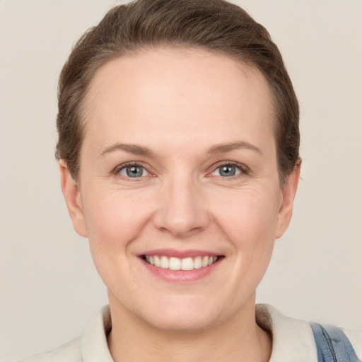 Joyful white adult female with short  brown hair and grey eyes