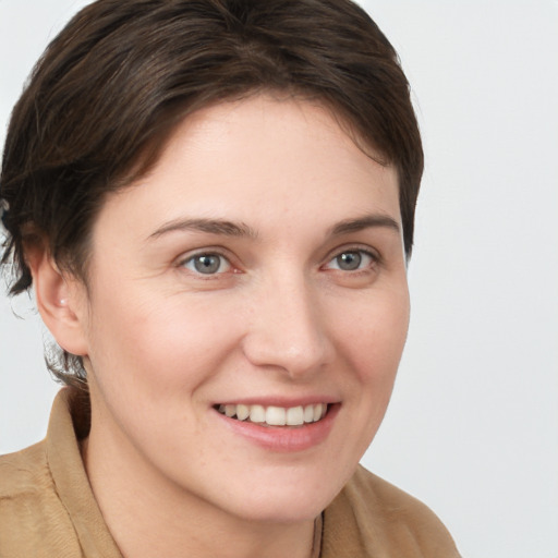 Joyful white young-adult female with long  brown hair and grey eyes