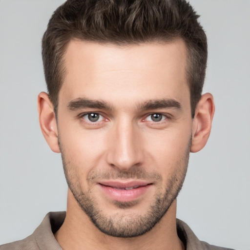 Joyful white young-adult male with short  brown hair and brown eyes