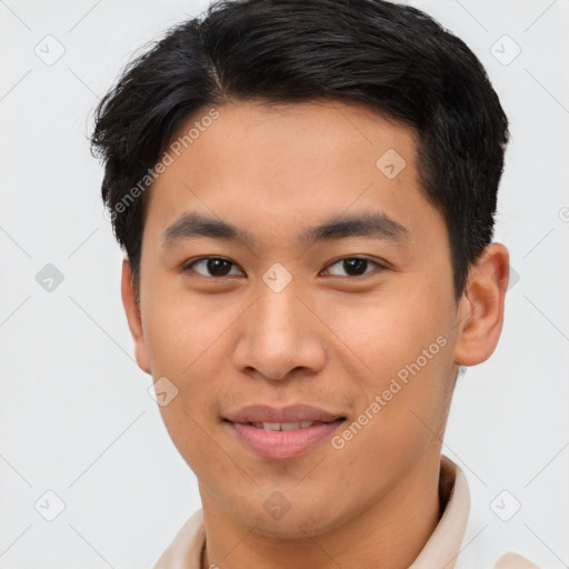 Joyful asian young-adult male with short  brown hair and brown eyes