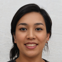 Joyful asian young-adult female with medium  black hair and brown eyes