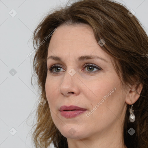 Joyful white adult female with long  brown hair and brown eyes