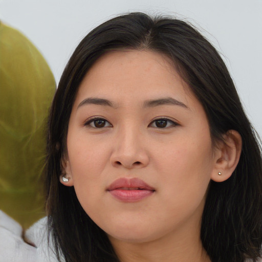 Joyful asian young-adult female with long  brown hair and brown eyes