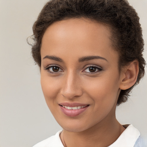 Joyful white young-adult female with short  brown hair and brown eyes