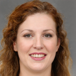 Joyful white young-adult female with long  brown hair and green eyes