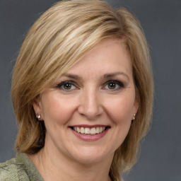 Joyful white adult female with medium  brown hair and grey eyes