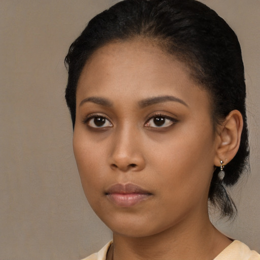 Neutral black young-adult female with medium  brown hair and brown eyes