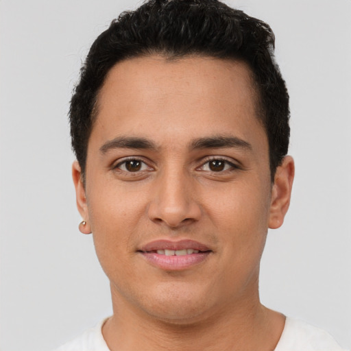 Joyful latino young-adult male with short  brown hair and brown eyes