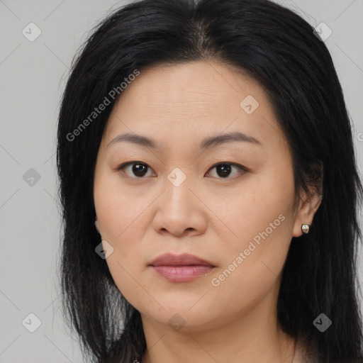 Joyful asian young-adult female with long  brown hair and brown eyes