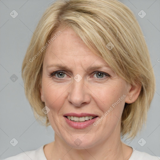 Joyful white adult female with medium  brown hair and blue eyes