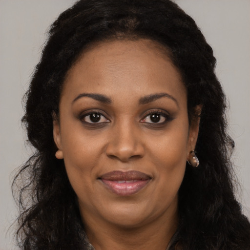 Joyful latino adult female with long  black hair and brown eyes
