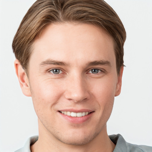 Joyful white young-adult male with short  brown hair and grey eyes