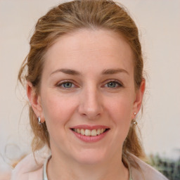 Joyful white young-adult female with medium  brown hair and blue eyes