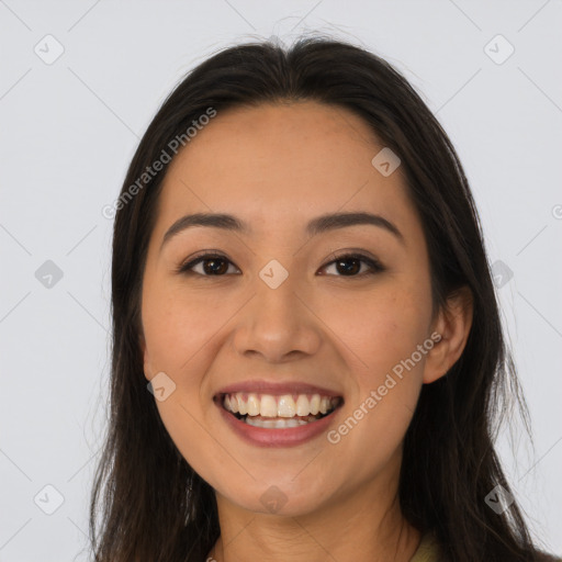 Joyful latino young-adult female with long  brown hair and brown eyes