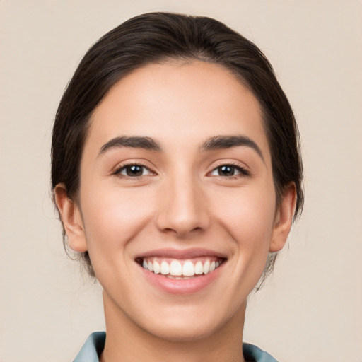 Joyful white young-adult female with medium  brown hair and brown eyes