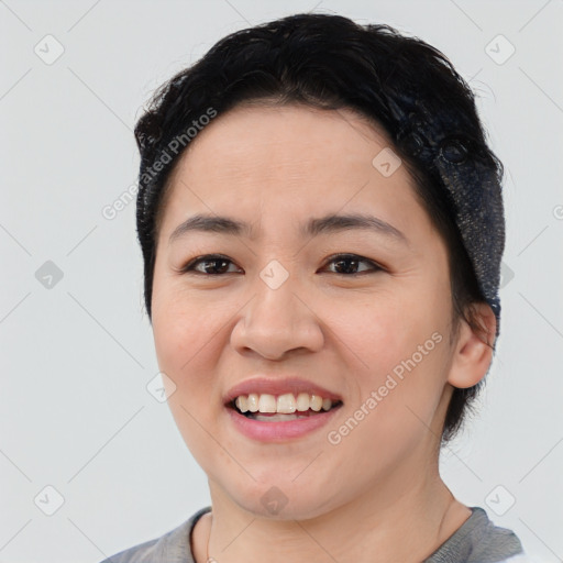 Joyful asian young-adult female with short  brown hair and brown eyes