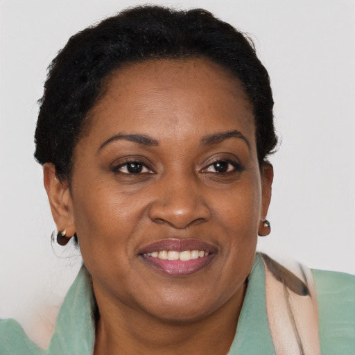 Joyful black adult female with short  brown hair and brown eyes