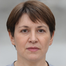 Joyful white adult female with short  brown hair and brown eyes