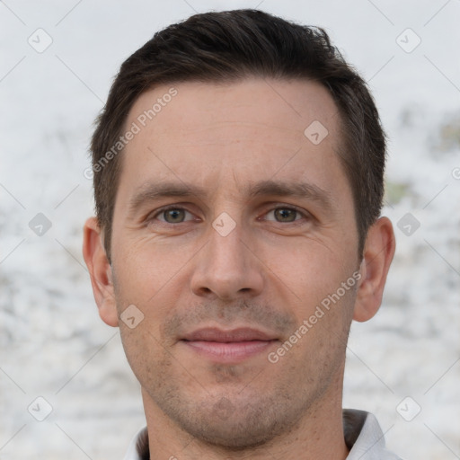 Joyful white adult male with short  brown hair and brown eyes