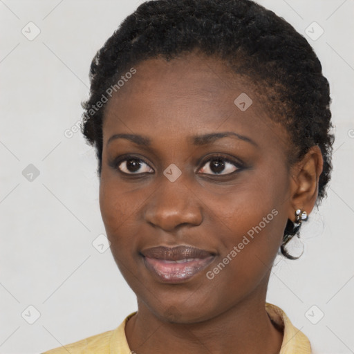 Joyful black young-adult female with short  black hair and brown eyes