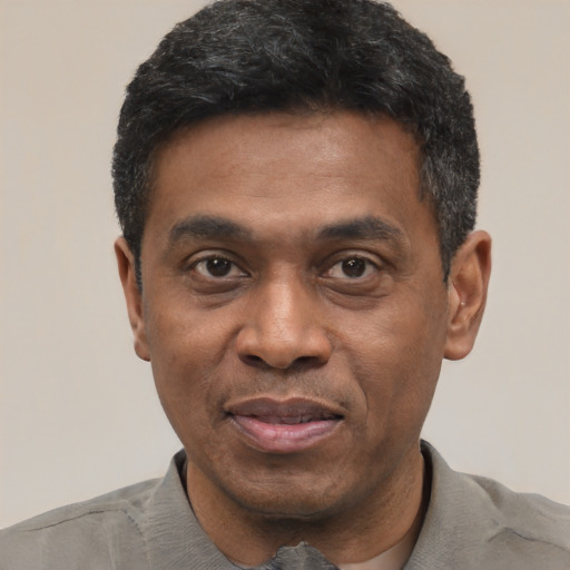 Joyful latino adult male with short  black hair and brown eyes