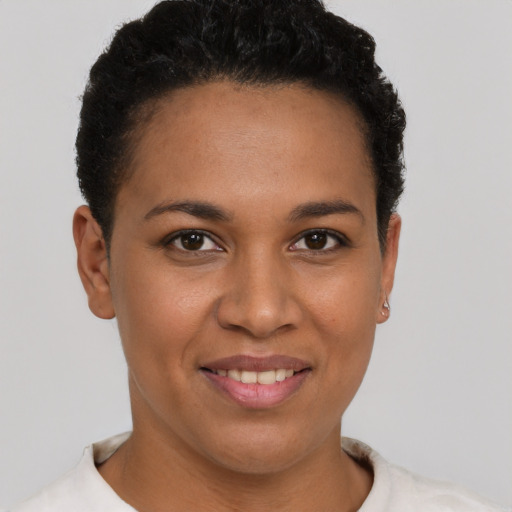 Joyful latino young-adult female with short  brown hair and brown eyes