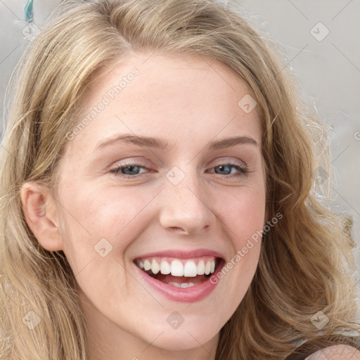 Joyful white young-adult female with long  brown hair and blue eyes