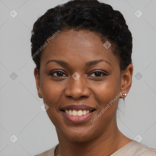 Joyful black young-adult female with short  black hair and brown eyes