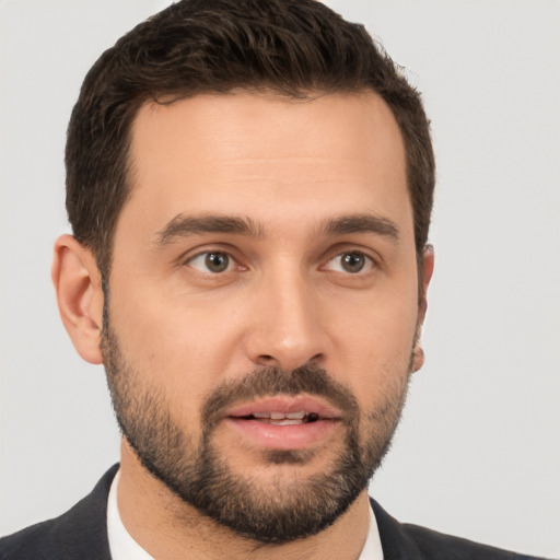 Joyful white young-adult male with short  brown hair and brown eyes