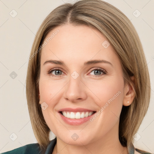 Joyful white young-adult female with medium  brown hair and green eyes