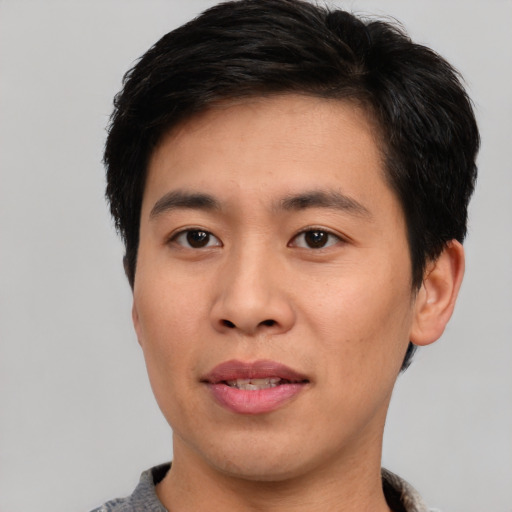 Joyful asian young-adult male with short  black hair and brown eyes