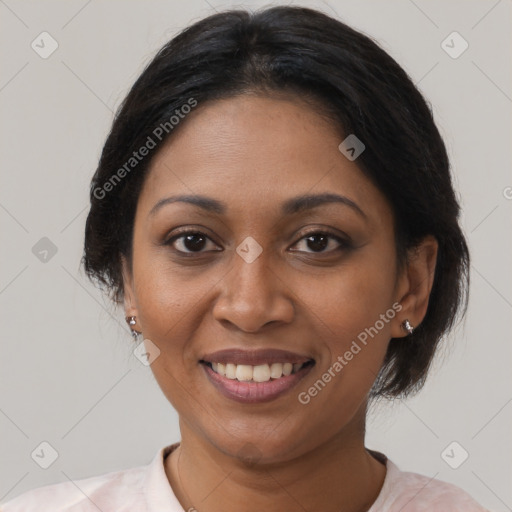 Joyful black adult female with medium  brown hair and brown eyes