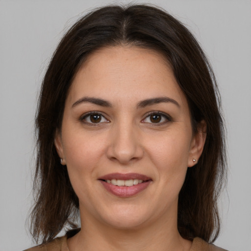 Joyful white young-adult female with medium  brown hair and brown eyes