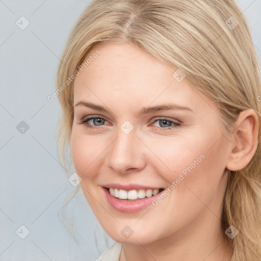 Joyful white young-adult female with long  brown hair and blue eyes