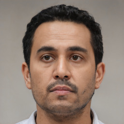 Neutral latino young-adult male with short  black hair and brown eyes