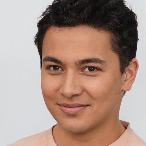 Joyful latino young-adult male with short  brown hair and brown eyes