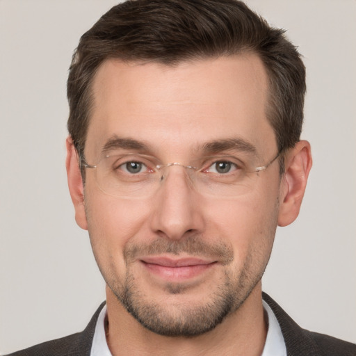 Joyful white adult male with short  brown hair and brown eyes