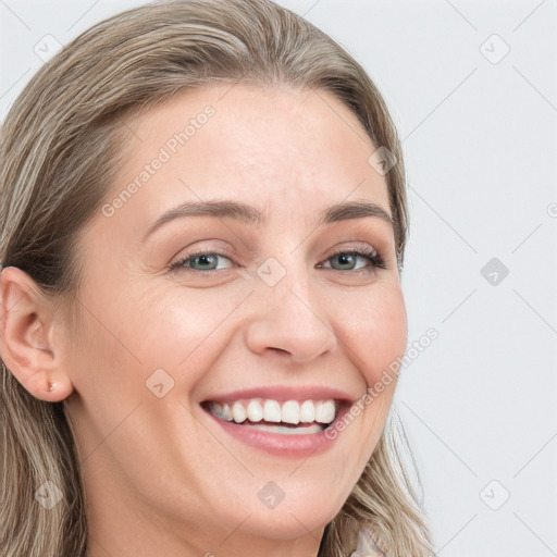 Joyful white young-adult female with long  brown hair and blue eyes