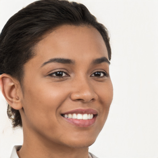 Joyful latino young-adult female with short  brown hair and brown eyes