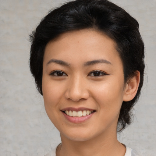 Joyful asian young-adult female with medium  brown hair and brown eyes