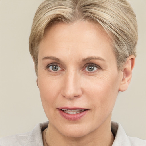 Joyful white adult female with short  brown hair and grey eyes