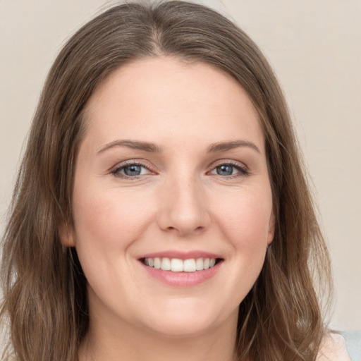 Joyful white young-adult female with long  brown hair and grey eyes