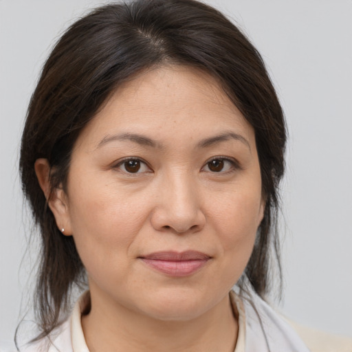 Joyful white adult female with medium  brown hair and brown eyes