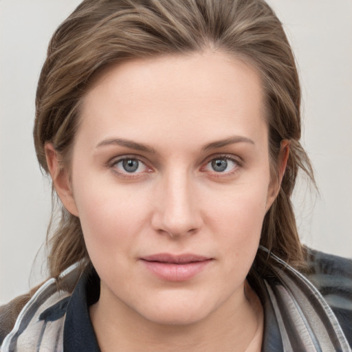 Joyful white young-adult female with medium  brown hair and blue eyes