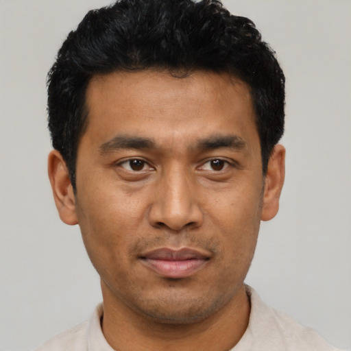 Joyful asian young-adult male with short  black hair and brown eyes