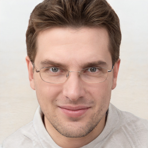 Joyful white adult male with short  brown hair and grey eyes