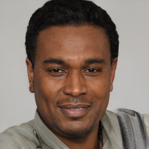 Joyful latino adult male with short  black hair and brown eyes