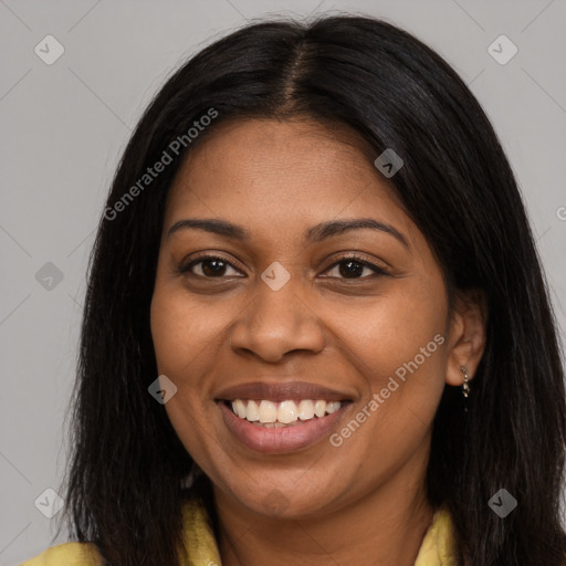 Joyful black young-adult female with long  brown hair and brown eyes