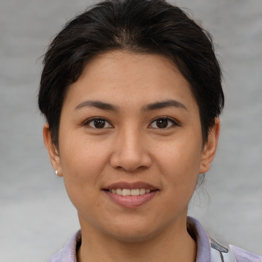 Joyful asian young-adult female with short  brown hair and brown eyes