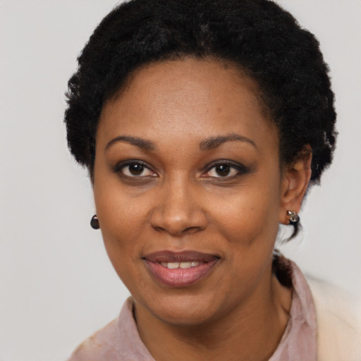 Joyful black adult female with short  black hair and brown eyes